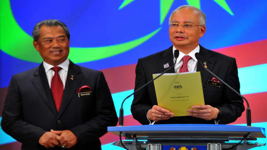 Malaysia's Prime Minister Najib Razak speaking with deputy Muhyiddin Yassin looking on.